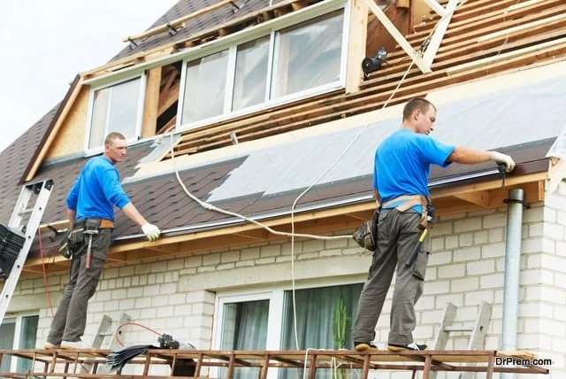 Picture of two Roofing Contractors installing faschia covers on the roof system